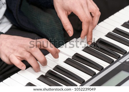 Hands of a pianist. Plays on the synthesizer. Selective focus