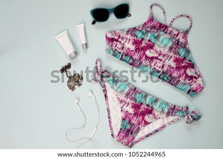 Top view summer vacation beach accessories on blue pastel background