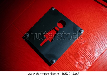 Bar cafe or restaurant woman toilet door with female wc sign or symbol. This toilet door is red and wooden. 