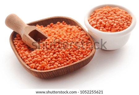 Some fresh lentil in scoop and bowl over white