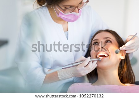 Dentist and patient in dentist office Royalty-Free Stock Photo #1052270132