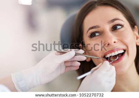 Woman having teeth examined at dentists Royalty-Free Stock Photo #1052270732
