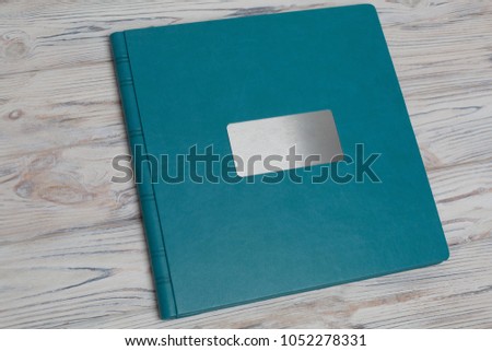   photo book on a white background.
Photo album on a wooden surface