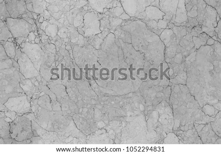 Light grey natural seamless granite marble stone texture pattern background. Rough natural stone seamless marble texture surface with cracks, dents, sharp edges. Gray grungy textured backdrop