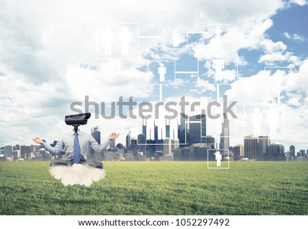 Elegant businessman outdoors floating on cloud and camera instead of head