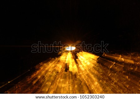 Street lamp with motion blur and leaves