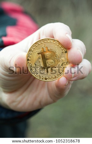 The female hands hold the three coin on the dark background
