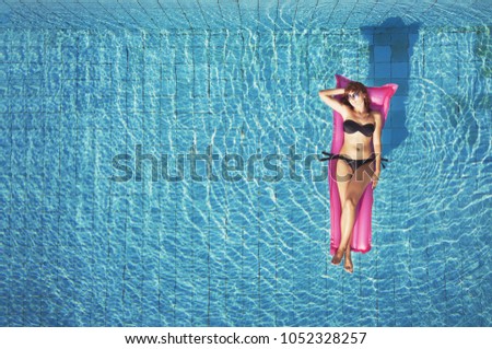 beautiful woman tourist in bikini swimming in luxury swimming pool of hotel, beach vacation travel, tropical holidays background with copyspace