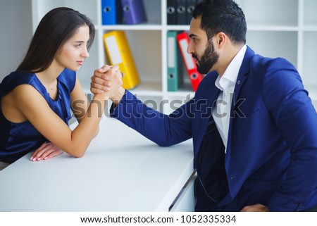 Man and woman doing arm wrestling