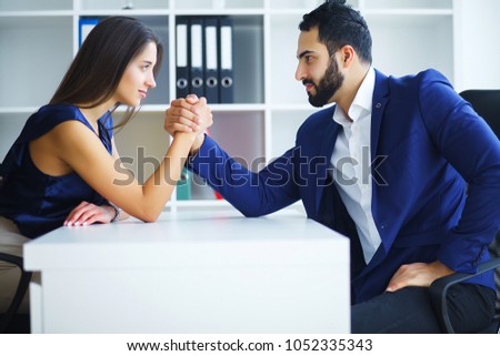 Man and woman doing arm wrestling