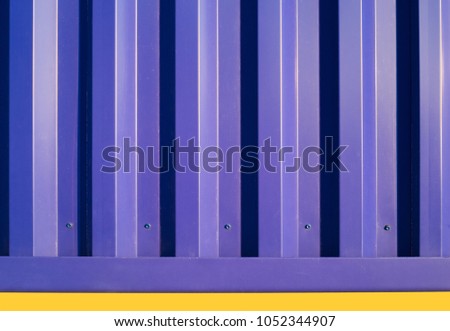 Shade and shadow from rim light effect during the sunset time the impact on the surface of the deep blue metal sheet wall.