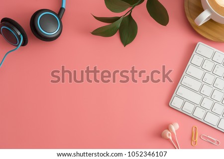 Styled stock photography pink office desk table with blank notebook, keyboard, macaroon, supplies and coffee cup. Top view with copy space. Flat lay.