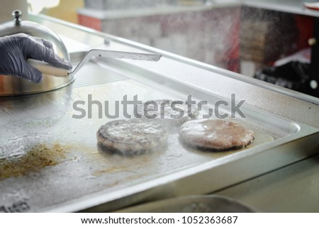 Fast food hamburgers take-away production cooking background