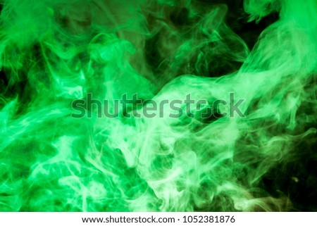 Thick green  colorful smoke  on a black isolated background. Background from the smoke of vape