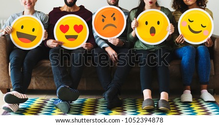 Group of diverse people holding emoticon icons Royalty-Free Stock Photo #1052394878