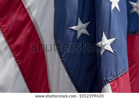 Detailed image of the stars and stripes of the American flag blowing in the wind.