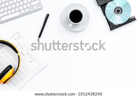 Work desk of modern composer. Music notes near headphones on white background top view copy space