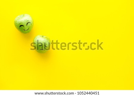 Basic emotions concept. Faces drawn on apples. Happy, smile, sad, angry, in love. Yellow background top view copy space