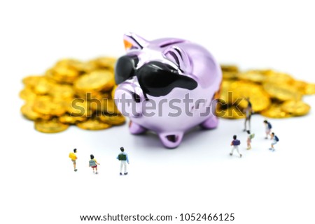Miniature people : children or student with Purple Piggy bank money  and gold coins.