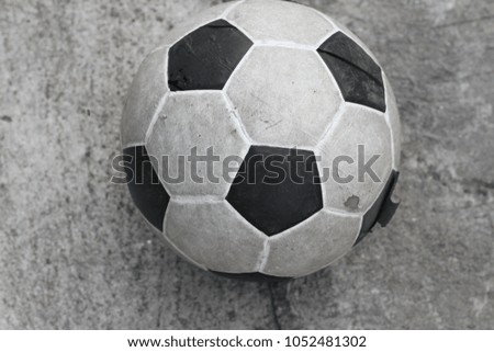 old football ball on concrete floor