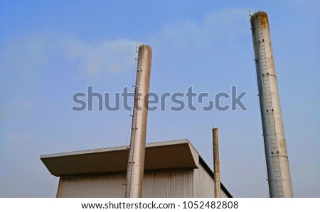 chimney on blue sky blue and white cloud background in Boiler factory