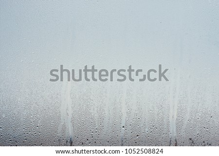 Water droplets condensation background of dew on glass, humidity and foggy blank. Outside , bad weather, rain Royalty-Free Stock Photo #1052508824