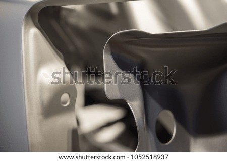 Metal parts of a car in automotive production .