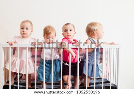 Three baby girls in the crib