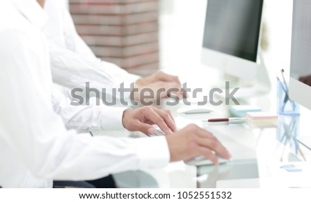hands typing text on the computer keyboard. blurred business background.