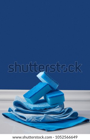 sponges and rags for spring cleaning on blue