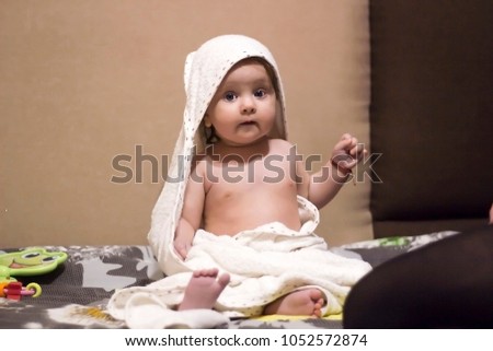 Small child is sitting with towel after bathing, vintage effect soft focus