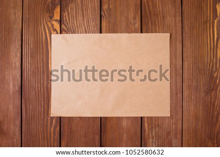 A piece of paper on a wooden background