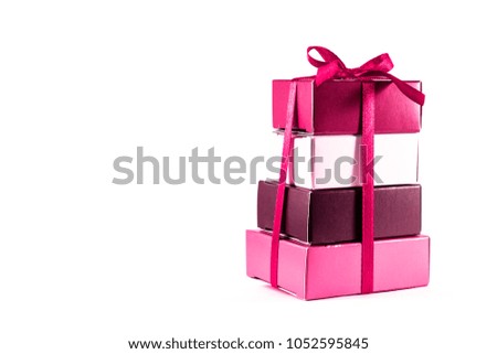 Gift boxes are red and white color stacked on top of each other isolated on white background.
