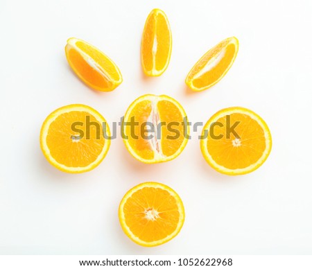 Top view of slices and whole of orange fruits on light background. Geometric composition of oranges.