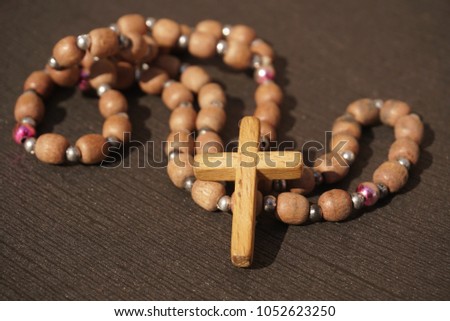 wooden rosary beads on dark background
