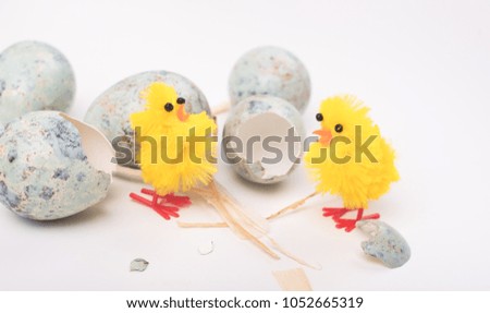 Easter composition with quail eggs and yellow chicken on a wooden backround. Top view. Holiday card.