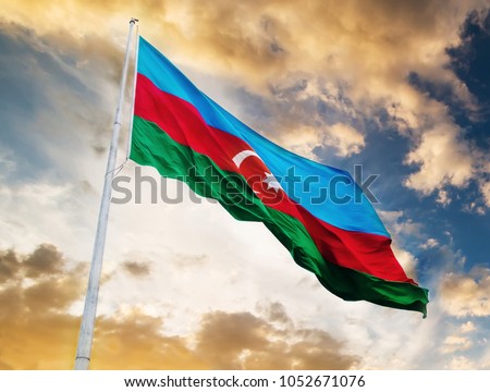 Azerbaijan flag waving against sunset sky