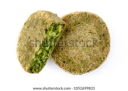 Grilled veggie hamburger with spinach and peas on white plate isolated on white background. Top view