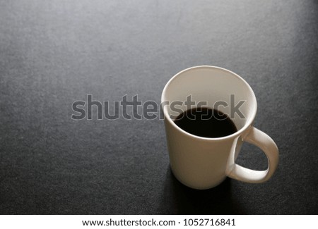 Coffee cup on black table copy space