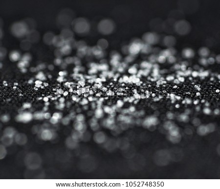 Ice glitter macro on black background.