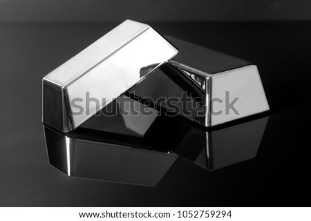 Silver bullion bars on black background Royalty-Free Stock Photo #1052759294