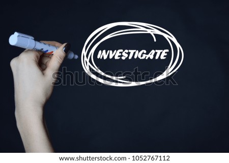 The businessman writes an inscription with a white marker:INVESTIGATE