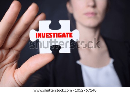 Businessman holding a puzzle with the inscription:INVESTIGATE