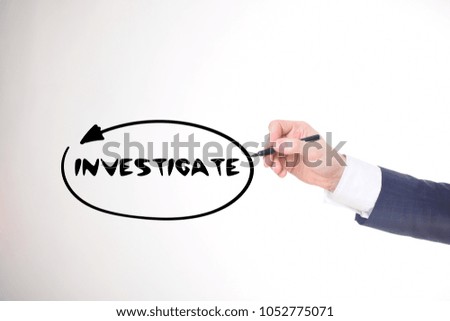 The businessman writes a black marker inscription:INVESTIGATE