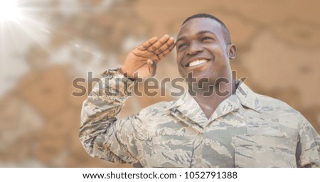 Digital composite of Soldier smiling and saluting against blurry brown map with flare