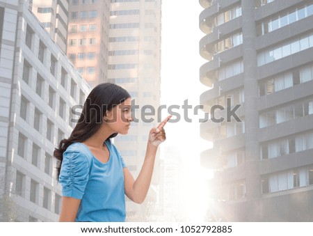 Digital composite of Woman pointing at tall buildings flare