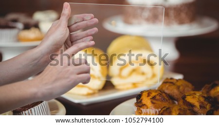 Digital composite of Hands taking picture of dessert with transparent device in coffee shop