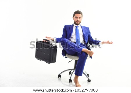 Man in suite or businessman with surprised face sit on office chair and hold briefcase, isolated on white background. Businessman changing office. Move out and replace concept.