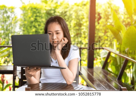Young female  using modern notebook at coffee shop, attractive businesswoman using portable computer during a break, flare light.Photo by selected focus.
