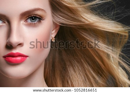 Woman with Curly long hair blonde young model. Beauty girl with perfect hairstyle. Studio shot.